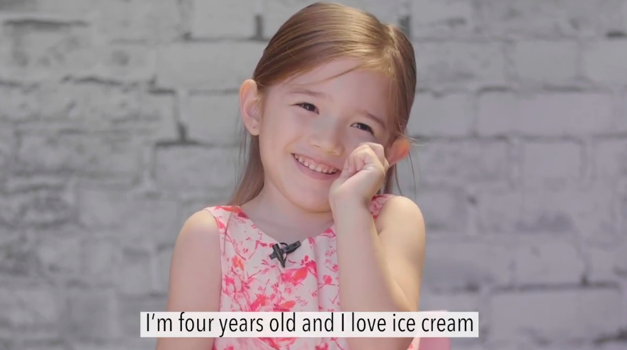 Smiling little girl, with a caption underneat that reads I am four years old and I love ice cream