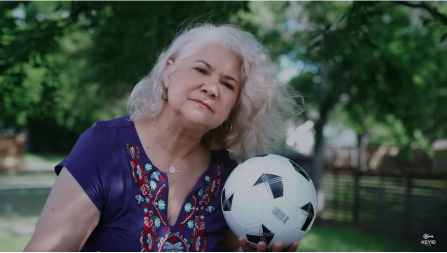 Older woman holding a soccer ball